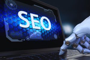Image of a robotic hand on a laptop, illustrating the intersection between technology and SEO strategies.