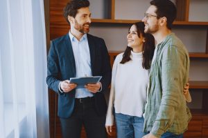 Realtor showing a house to a couple.