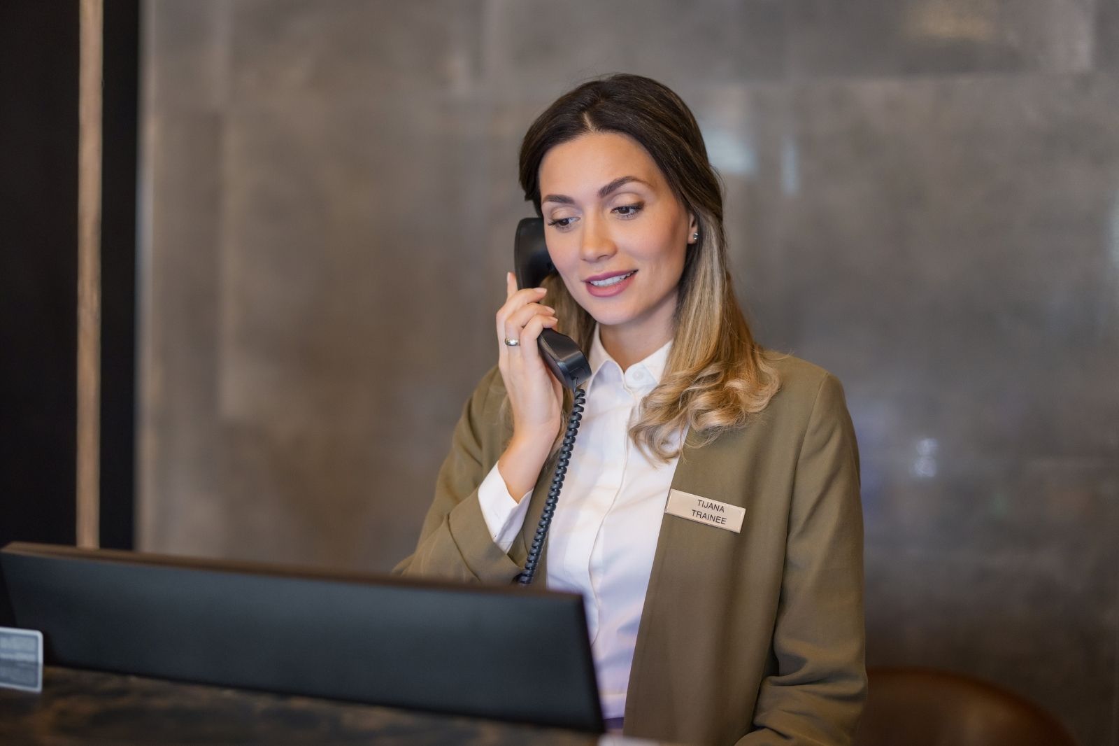 Hotel receptionist attending to reservation
