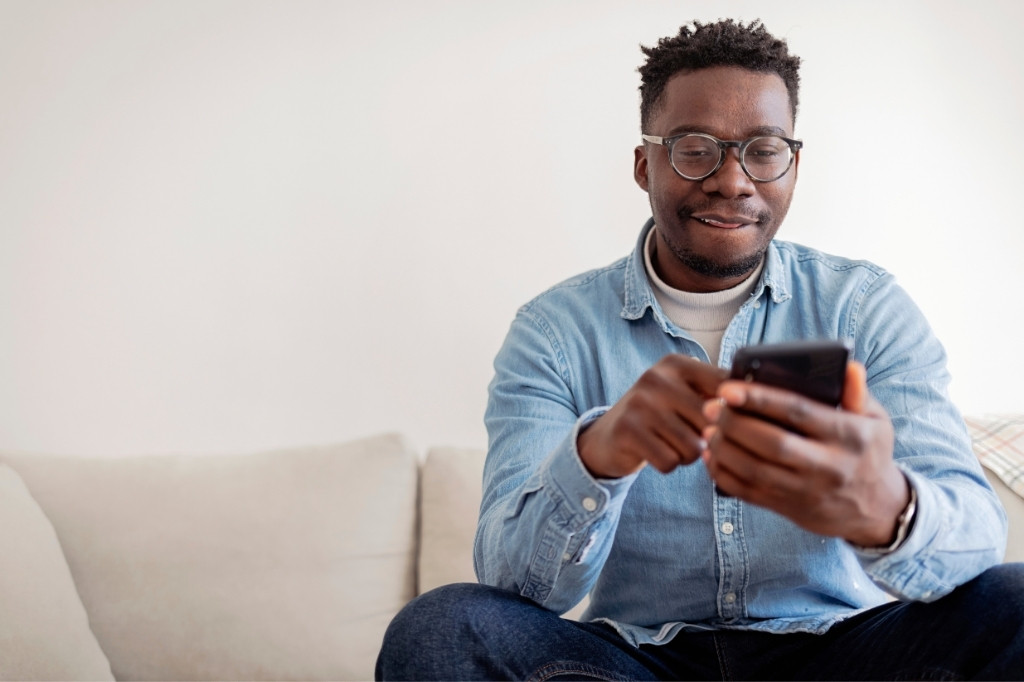 Cliente usando smartphone para interactuar con marca, reflejando gestión de crisis digital y respuesta a reputación online en restaurante.